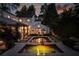 Backyard view of the pool and landscaped patio at twilight at 820 Highland Ne Ter, Atlanta, GA 30306