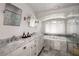 Luxurious bathroom featuring marble countertops, a soaking tub, and a glass-enclosed shower at 820 Highland Ne Ter, Atlanta, GA 30306