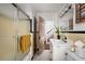 Well-lit bathroom with black and beige tiling, a glass shower door and an open doorway at 820 Highland Ne Ter, Atlanta, GA 30306