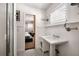 Bathroom showing a pedestal sink, beadboard paneling, and a view into the bedroom at 820 Highland Ne Ter, Atlanta, GA 30306