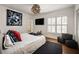 A beautifully staged bedroom with white walls, wooden floors, a dark blue rug and unique light fixture at 820 Highland Ne Ter, Atlanta, GA 30306