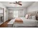 Cozy bedroom with a tufted headboard, window, and doorway to a bath at 820 Highland Ne Ter, Atlanta, GA 30306