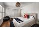 A brightly lit bedroom with white walls, wooden floors, a closet and unique light fixture at 820 Highland Ne Ter, Atlanta, GA 30306