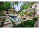 Scenic pool area with stepping stones, cabana, covered patio, and lush greenery at 820 Highland Ne Ter, Atlanta, GA 30306