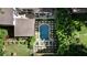 Aerial view of a backyard featuring a rectangular pool and an adjacent hot tub surrounded by landscaped greenery and stone tiling at 820 Highland Ne Ter, Atlanta, GA 30306