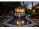 Backyard swimming pool and spa with accent lighting and waterfall features at 820 Highland Ne Ter, Atlanta, GA 30306