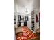 Organized walk-in closet featuring a window, shelves, rods and an eye-catching rug on the wood floor at 820 Highland Ne Ter, Atlanta, GA 30306