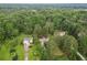 Expansive aerial view of wooded property with lush landscaping and charming homes nestled among mature trees at 117 Laguna Springs Dr, Woodstock, GA 30188