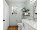 Bright bathroom featuring tiled floors, a decorative window, and built-in storage shelves at 117 Laguna Springs Dr, Woodstock, GA 30188