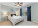 Comfortable bedroom with a ceiling fan, natural light, and carpeted floors at 117 Laguna Springs Dr, Woodstock, GA 30188