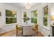 Cozy breakfast nook features lots of natural light and a modern chandelier at 117 Laguna Springs Dr, Woodstock, GA 30188