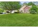 Charming home featuring a lush green lawn and mature trees at 117 Laguna Springs Dr, Woodstock, GA 30188