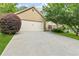 Attached two-car garage with a concrete driveway and manicured landscaping at 117 Laguna Springs Dr, Woodstock, GA 30188