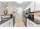 Contemporary kitchen with stainless steel appliances, granite counters, and white cabinets at 117 Laguna Springs Dr, Woodstock, GA 30188