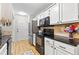 Clean kitchen featuring stainless appliances, white cabinets, and granite countertops at 117 Laguna Springs Dr, Woodstock, GA 30188
