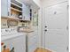Functional laundry room featuring storage cabinets, shelving, and a utility sink at 117 Laguna Springs Dr, Woodstock, GA 30188
