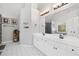 Well-lit bathroom featuring double vanity with white cabinets, a large mirror, and modern fixtures at 117 Willow View Ln, Canton, GA 30114