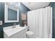 Bathroom with white sink, dark blue walls, white shower curtain and plenty of light at 117 Willow View Ln, Canton, GA 30114