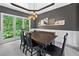 Bright dining room features a large window, stylish lighting, and a dark wood table with bench seating at 117 Willow View Ln, Canton, GA 30114