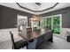 Spacious dining room with stylish lighting, a large window, and dark wood table with bench seating at 117 Willow View Ln, Canton, GA 30114