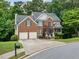Attractive two-story home featuring a brick facade, a two-car garage, and a well-maintained lawn at 117 Willow View Ln, Canton, GA 30114
