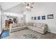Spacious living room features high ceilings, a ceiling fan, large windows, and flows into an open-concept kitchen at 117 Willow View Ln, Canton, GA 30114