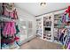 Spacious walk-in closet with custom shelving, ample storage, and natural light from the window at 117 Willow View Ln, Canton, GA 30114