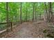 Wooded trail with trees and foliage; the path leads toward a wooden fence in the distance at 117 Willow View Ln, Canton, GA 30114