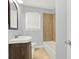 Cozy bathroom featuring tiled floors, a bathtub, and a wood vanity at 2505 Mellville Ave, Decatur, GA 30032