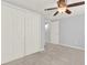 Bedroom with gray carpet and walls, white trim, fan, and closet at 2505 Mellville Ave, Decatur, GA 30032