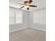 Bright bedroom with neutral carpet, large windows and a ceiling fan with light fixture at 2505 Mellville Ave, Decatur, GA 30032