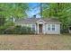 Charming single-story home with gray siding, surrounded by lush trees at 2505 Mellville Ave, Decatur, GA 30032