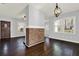 Inviting living room with a decorative brick column, hardwood floors, and a charming front door at 2505 Mellville Ave, Decatur, GA 30032