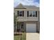 Charming two-story townhome featuring a brick-accented garage and neutral siding at 2808 Lillian Ln, Douglasville, GA 30135