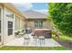 Inviting back patio featuring a hot tub, seating area, grill, and well-maintained yard at 332 Rosshandler Rd, Suwanee, GA 30024
