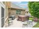 Inviting back patio featuring a hot tub, seating area, grill, and well-maintained yard at 332 Rosshandler Rd, Suwanee, GA 30024