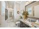 Well-lit bathroom with a marble-tiled floor, single sink vanity, and a glass-enclosed shower at 332 Rosshandler Rd, Suwanee, GA 30024