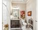 Cozy half bath featuring a single sink vanity, decorative art, and modern fixtures at 332 Rosshandler Rd, Suwanee, GA 30024