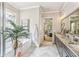 Bright bathroom with herringbone tile and dark wood cabinets at 332 Rosshandler Rd, Suwanee, GA 30024