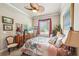 Charming bedroom featuring a floral bedspread, ceiling fan, and ample natural light from the window at 332 Rosshandler Rd, Suwanee, GA 30024
