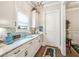 Butler's pantry features marble countertops and white cabinets at 332 Rosshandler Rd, Suwanee, GA 30024