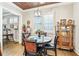 Charming dining area with a round table, wooden chairs, and a decorative ceiling at 332 Rosshandler Rd, Suwanee, GA 30024