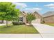 Charming brick home featuring a well-manicured lawn, landscaped garden beds, and a two-car garage at 332 Rosshandler Rd, Suwanee, GA 30024