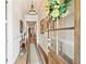 Inviting hallway features hardwood floors, detailed trim, and natural light streaming from the front door at 332 Rosshandler Rd, Suwanee, GA 30024