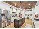 Spacious kitchen with stainless steel appliances, granite countertops, and a copper-style tile ceiling at 332 Rosshandler Rd, Suwanee, GA 30024