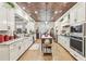 Gourmet kitchen featuring white cabinets, stainless appliances, and a large center island at 332 Rosshandler Rd, Suwanee, GA 30024