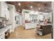 Spacious kitchen featuring white cabinets, a center island, and stainless steel appliances at 332 Rosshandler Rd, Suwanee, GA 30024