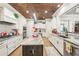 Modern kitchen with a center island, granite countertops, stainless steel appliances and copper colored ceiling at 332 Rosshandler Rd, Suwanee, GA 30024