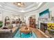 Cozy living room with fireplace, tufted sofa, and a large flat-screen TV at 332 Rosshandler Rd, Suwanee, GA 30024