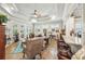 Open-concept living room with tray ceilings, hardwood floors, and a bar with granite countertop at 332 Rosshandler Rd, Suwanee, GA 30024